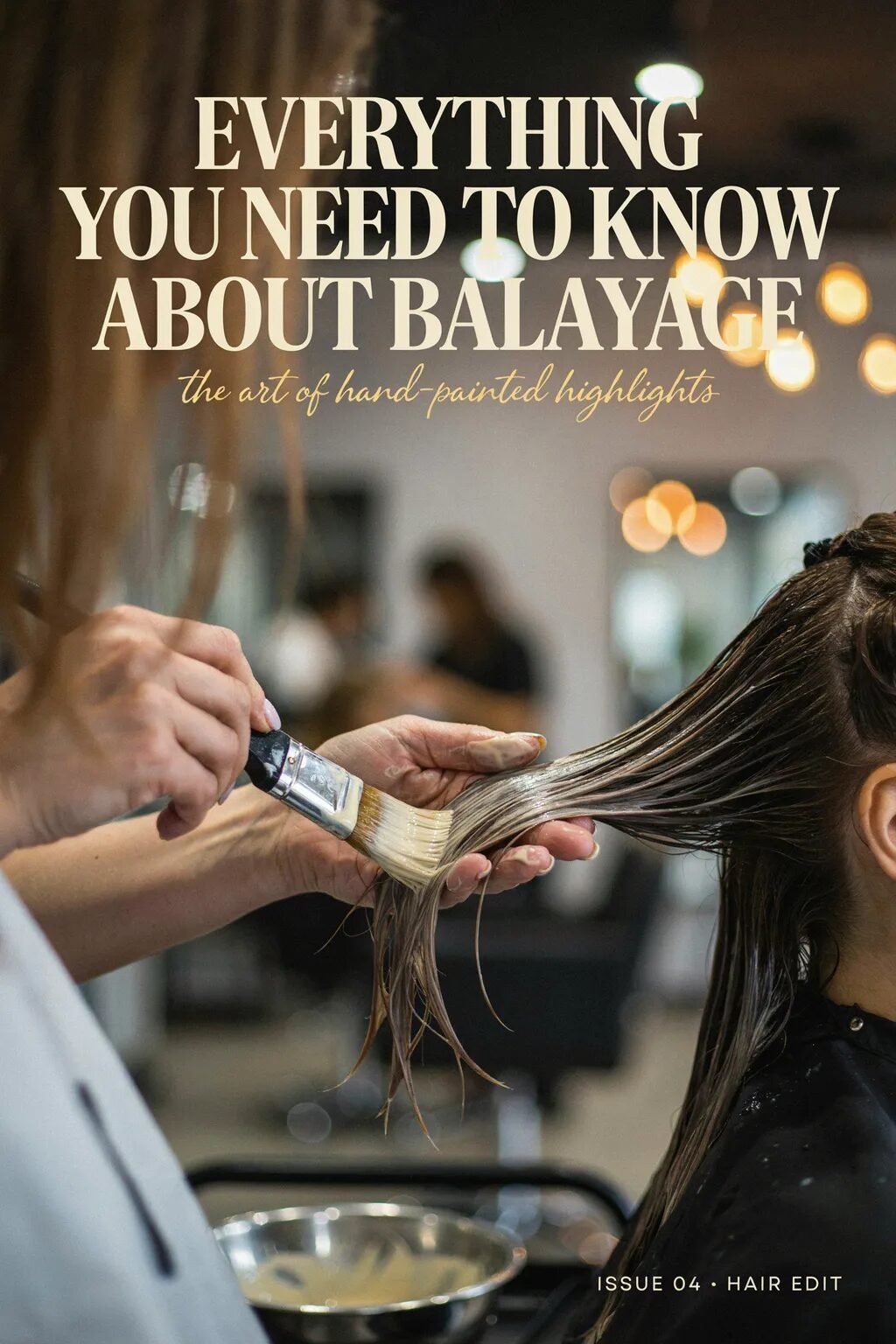 Close-up of a salon professional painting lightener onto a client's strands with a brush.